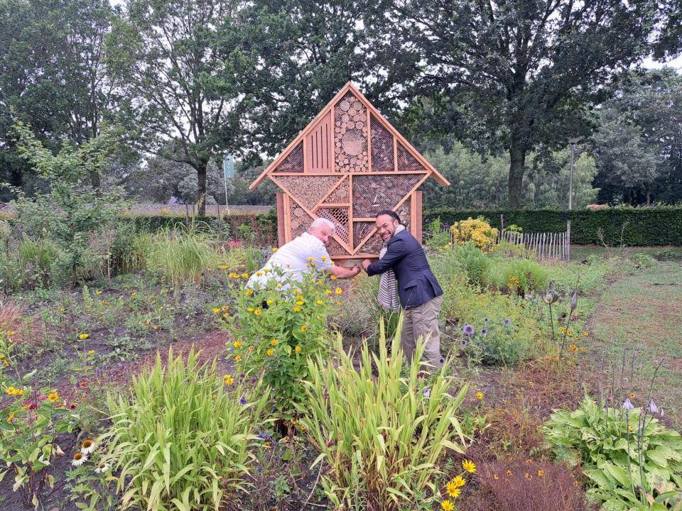 Wethouder Ririhena en Ad Duijn van de Stiep hangen bordje op insectenhotel